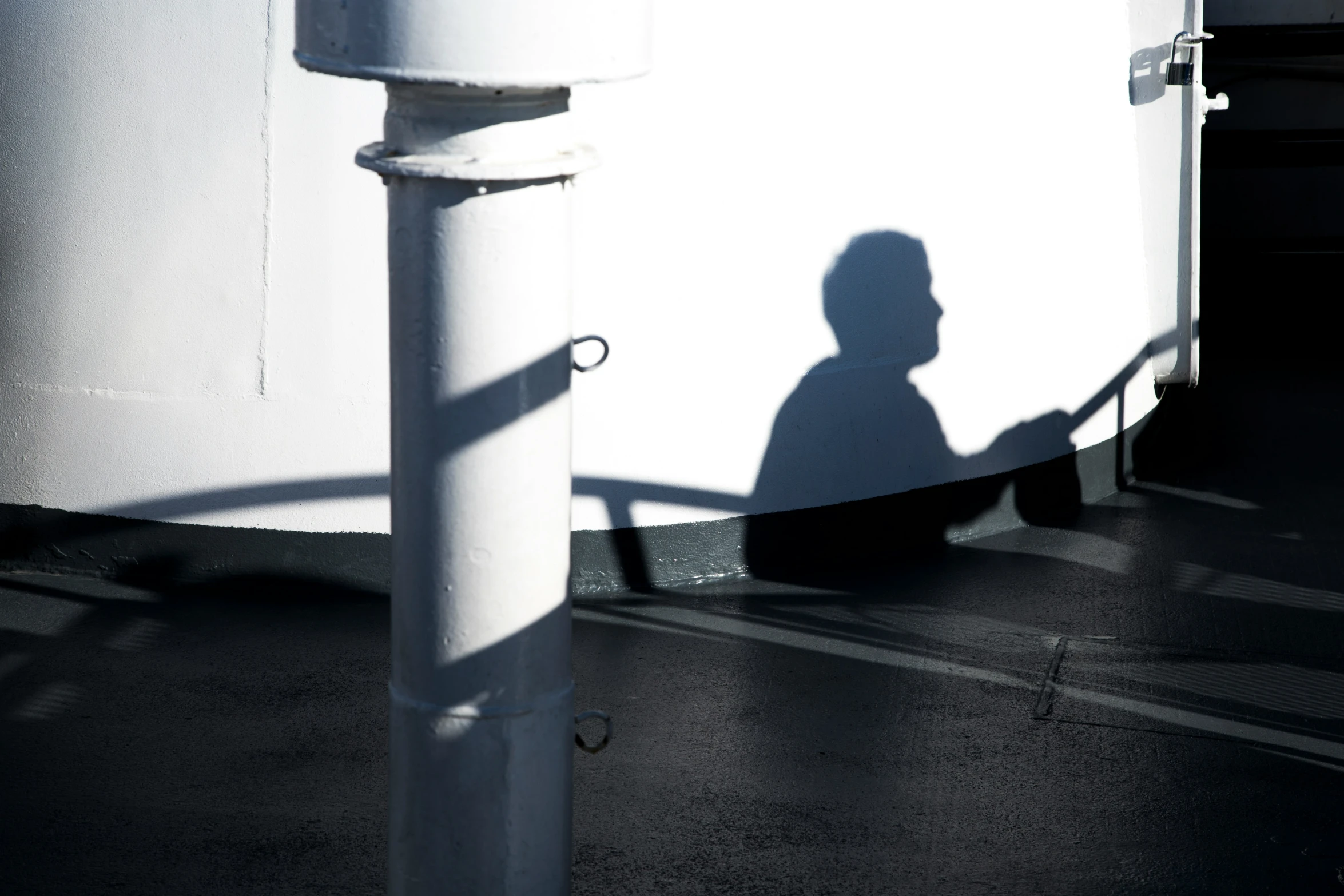 an image of a man who is leaning against a pole