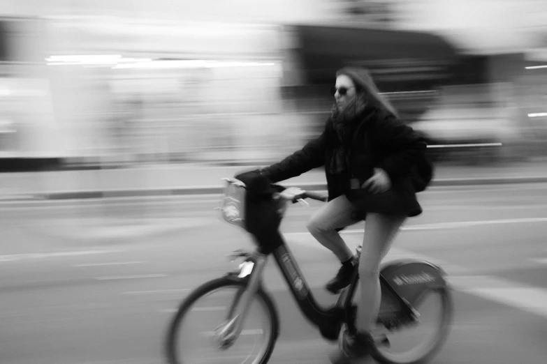 a girl riding on the back of a bike