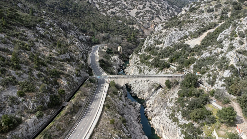 a highway passing over a cliff with bridge below