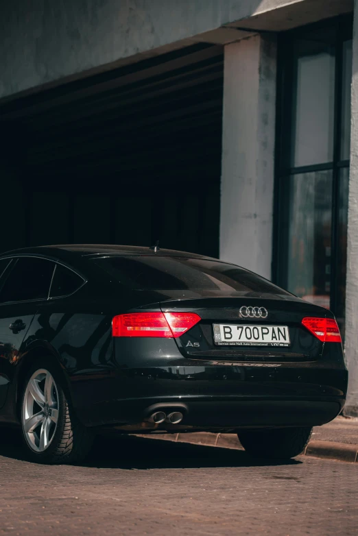 an empty black car parked in a garage