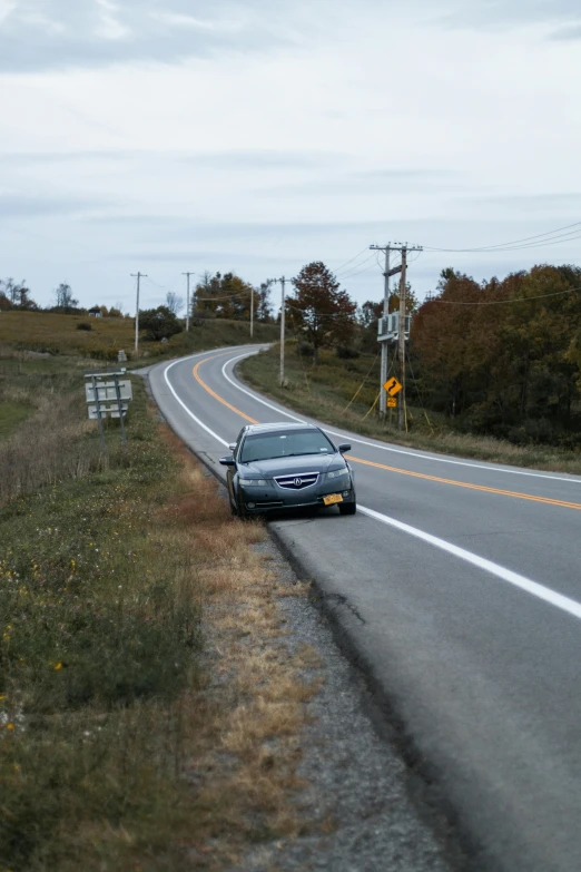 a blue car on the road is making its way