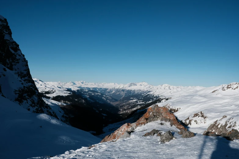 man on skis standing at the top of a mountain