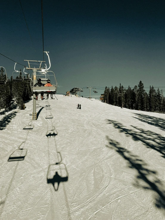 a ski lift is above the snow and trees