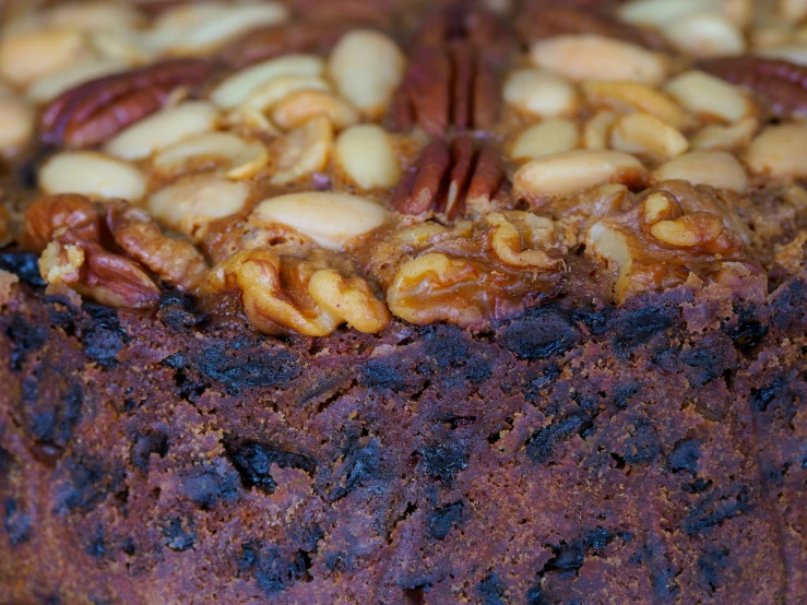 a chocolate cake is topped with nuts and almonds