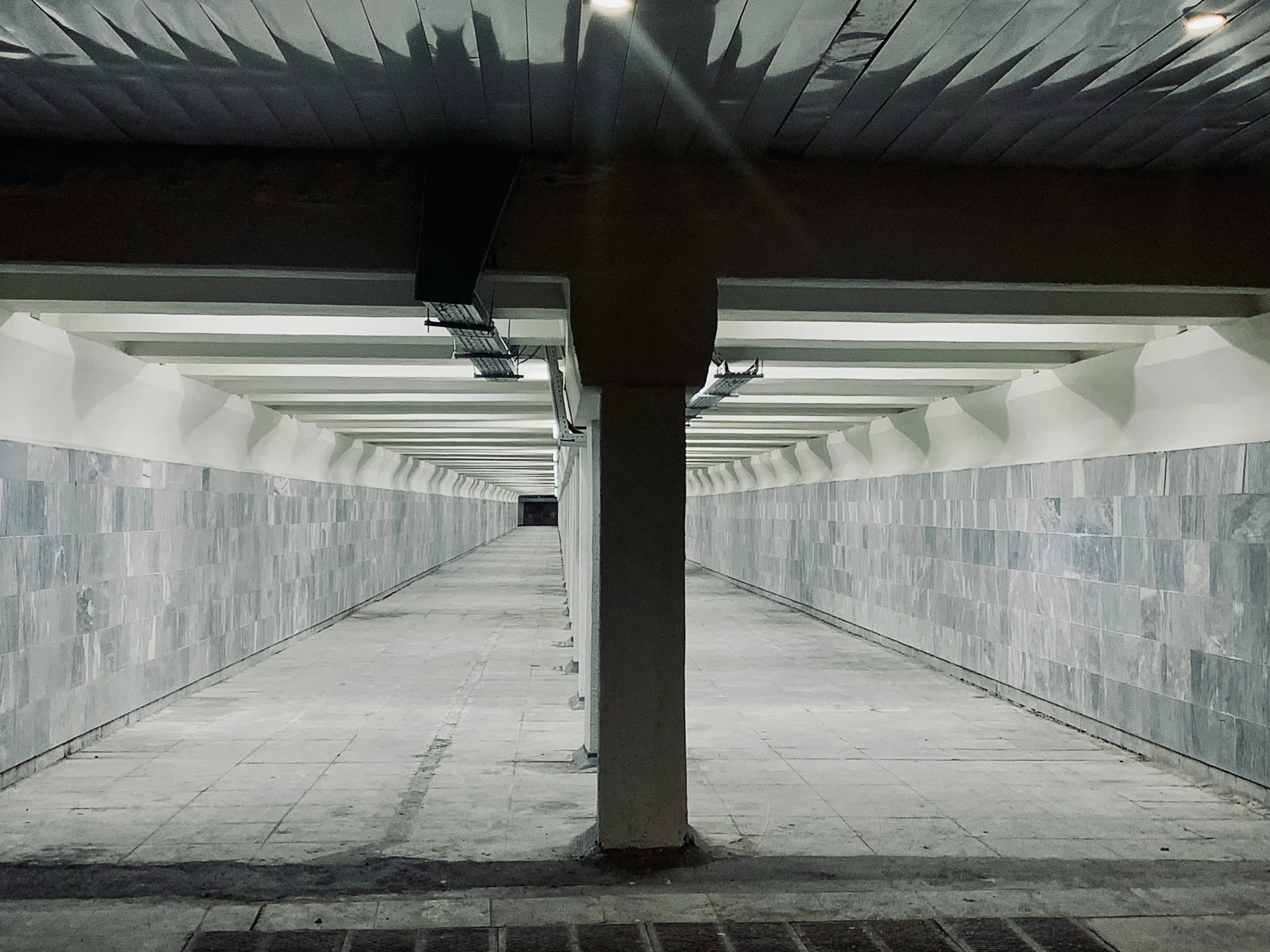 an empty parking garage with concrete floors and white walls