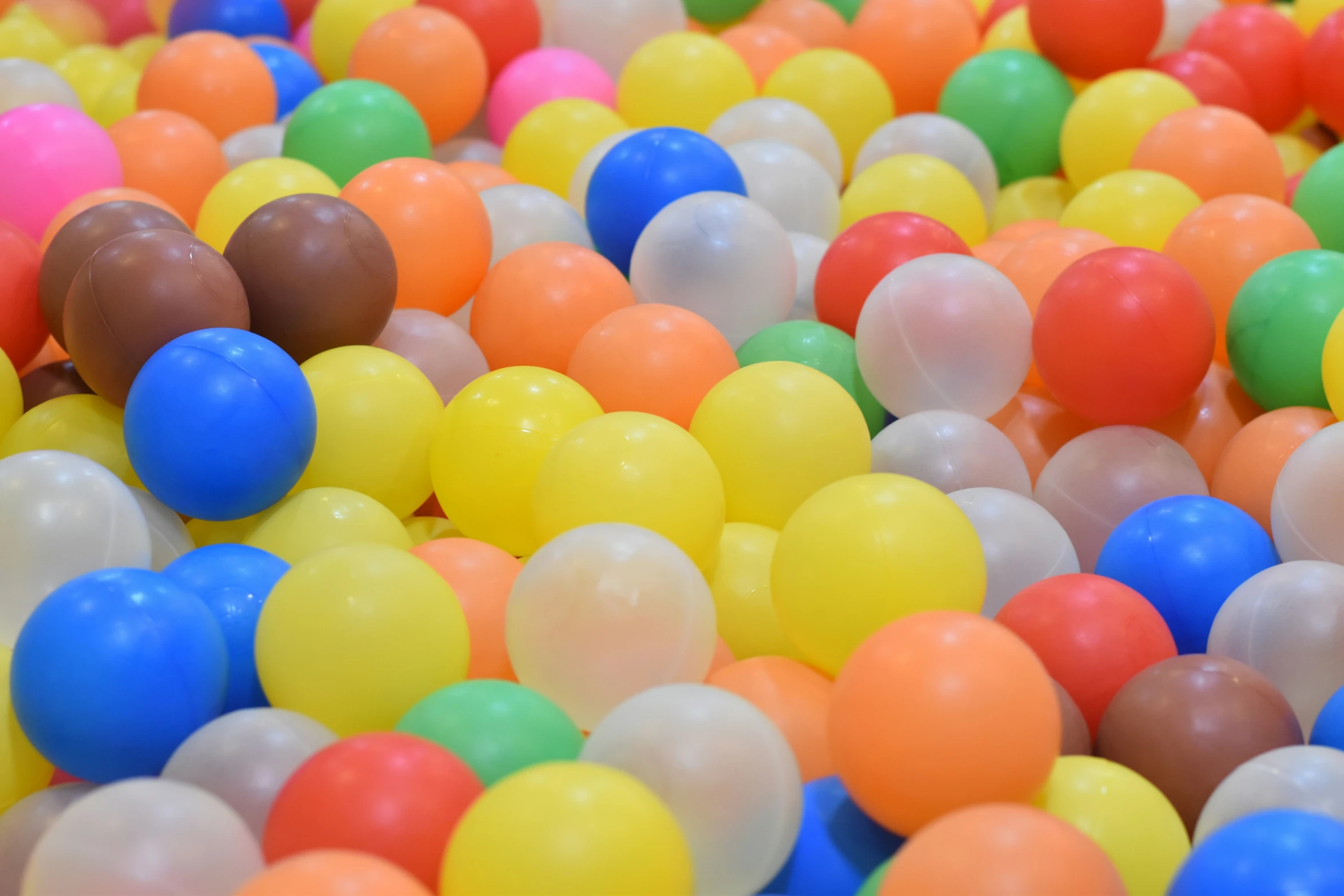 many different colored balls scattered together in a pool