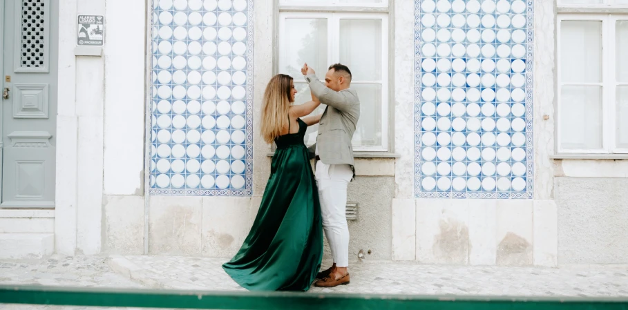 a couple leaning against a wall during their pre - wedding session