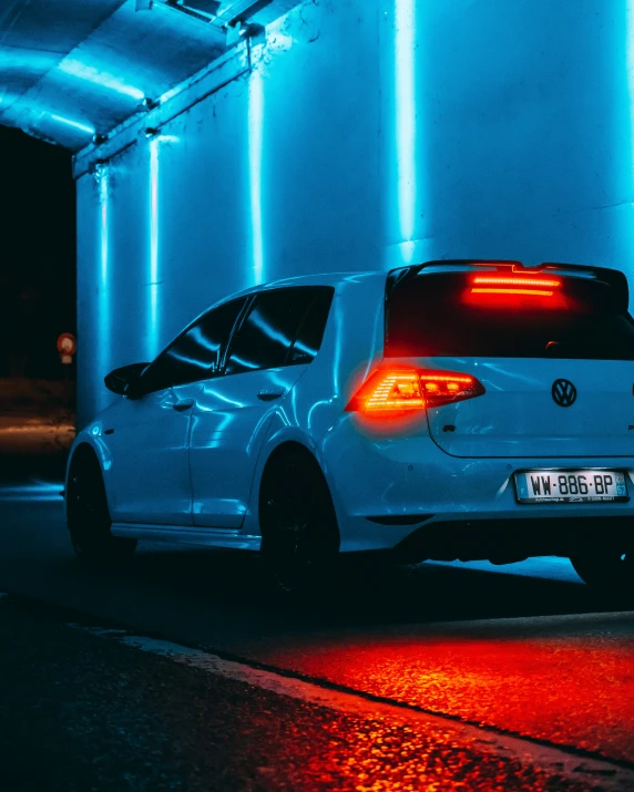 the back end of a white golf car on a street