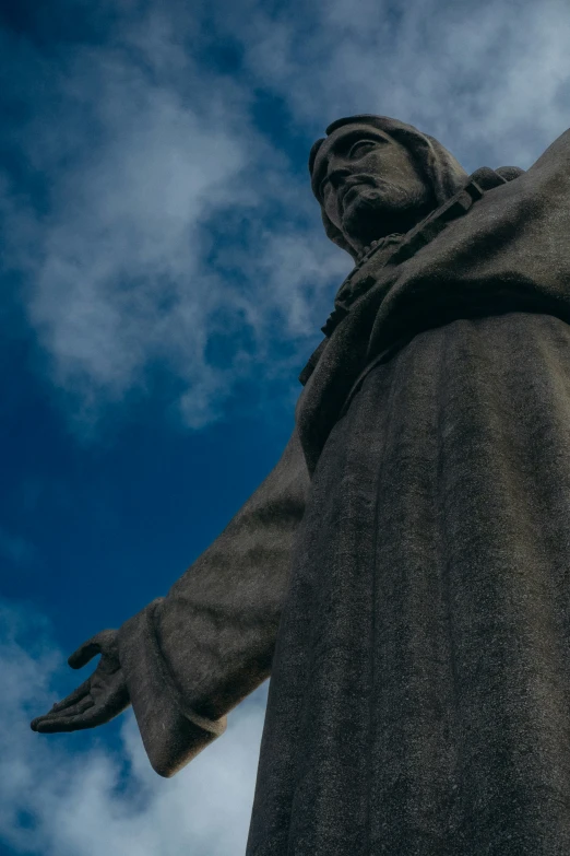 the giant statue has his hands raised for peace