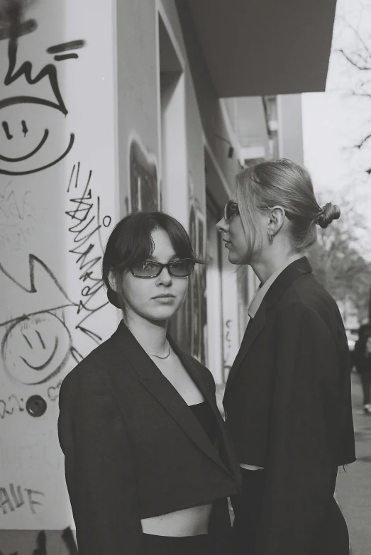 two women that are standing next to each other