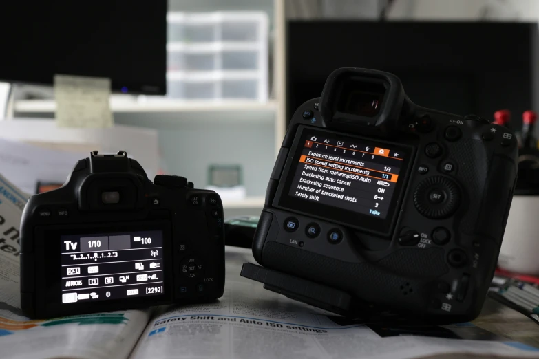 there are two cameras next to each other on the table