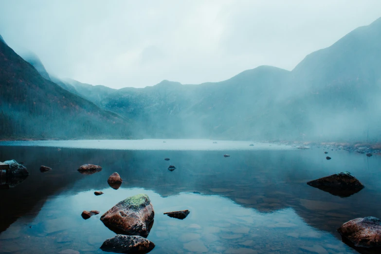 an image of a large body of water with rocks on the ground