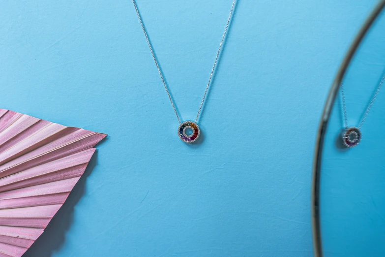 a blue background with some necklaces on it