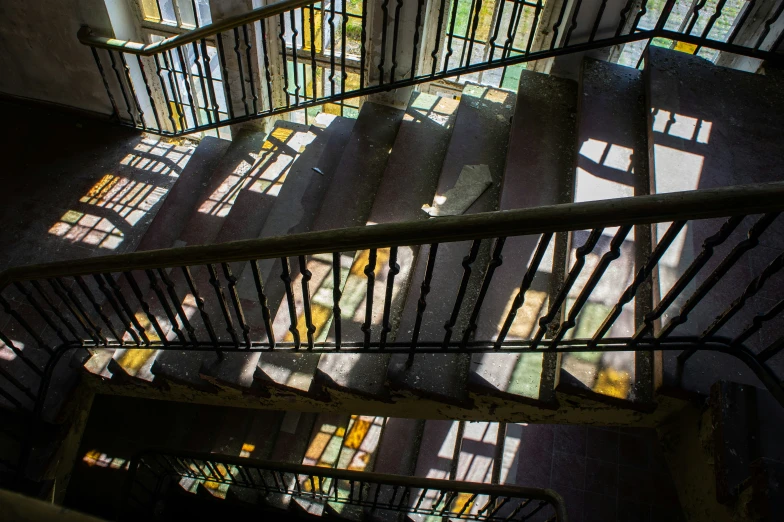 a group of stair railings next to stained glass windows