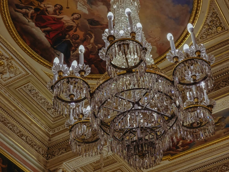 a chandelier hanging from the ceiling in a palace