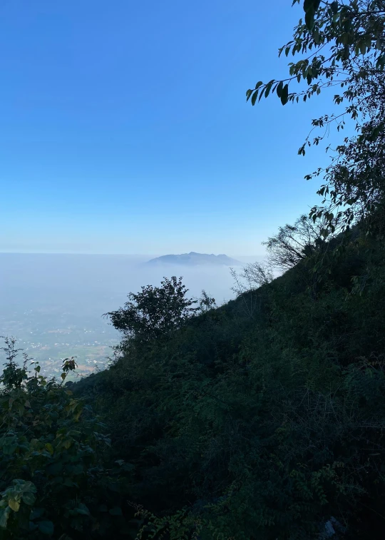 a view from a hill overlooking a small town in the distance