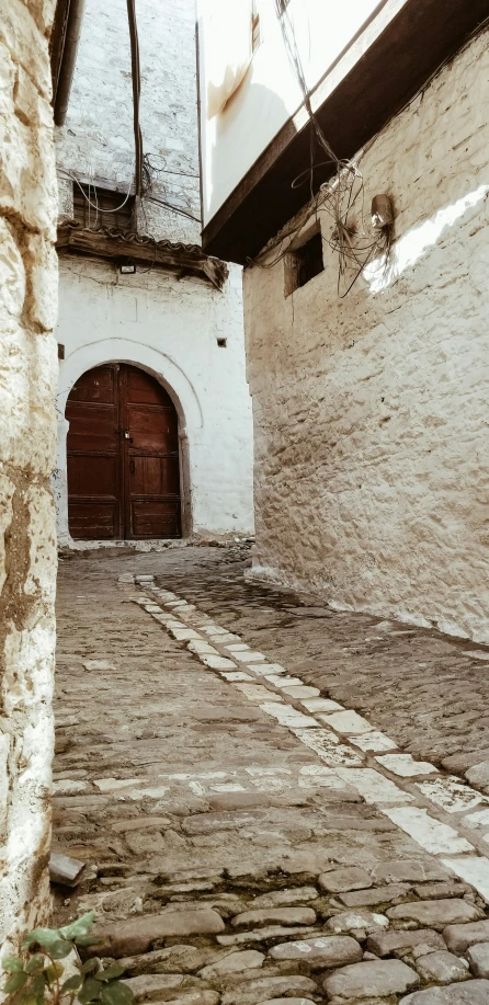 an alley with old brick and stone walkways