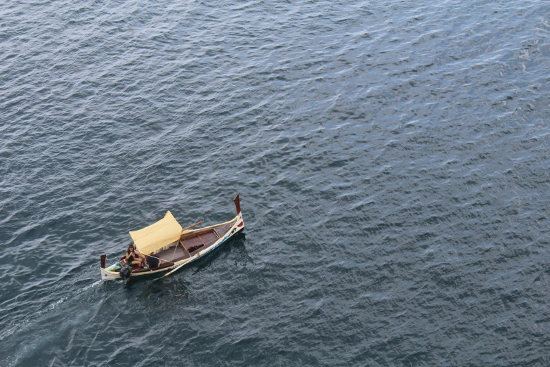 a small boat sailing across a large body of water
