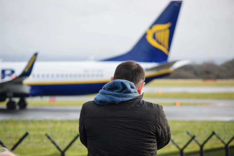a person is watching two planes on the runway