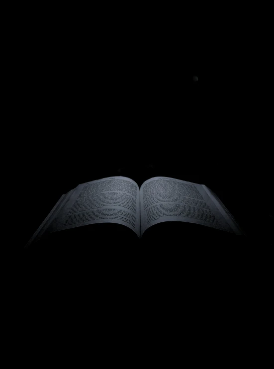 a book opened on its side in the dark