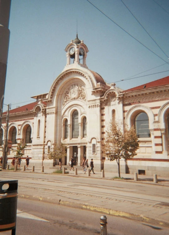 a couple of people walking outside a church next to street