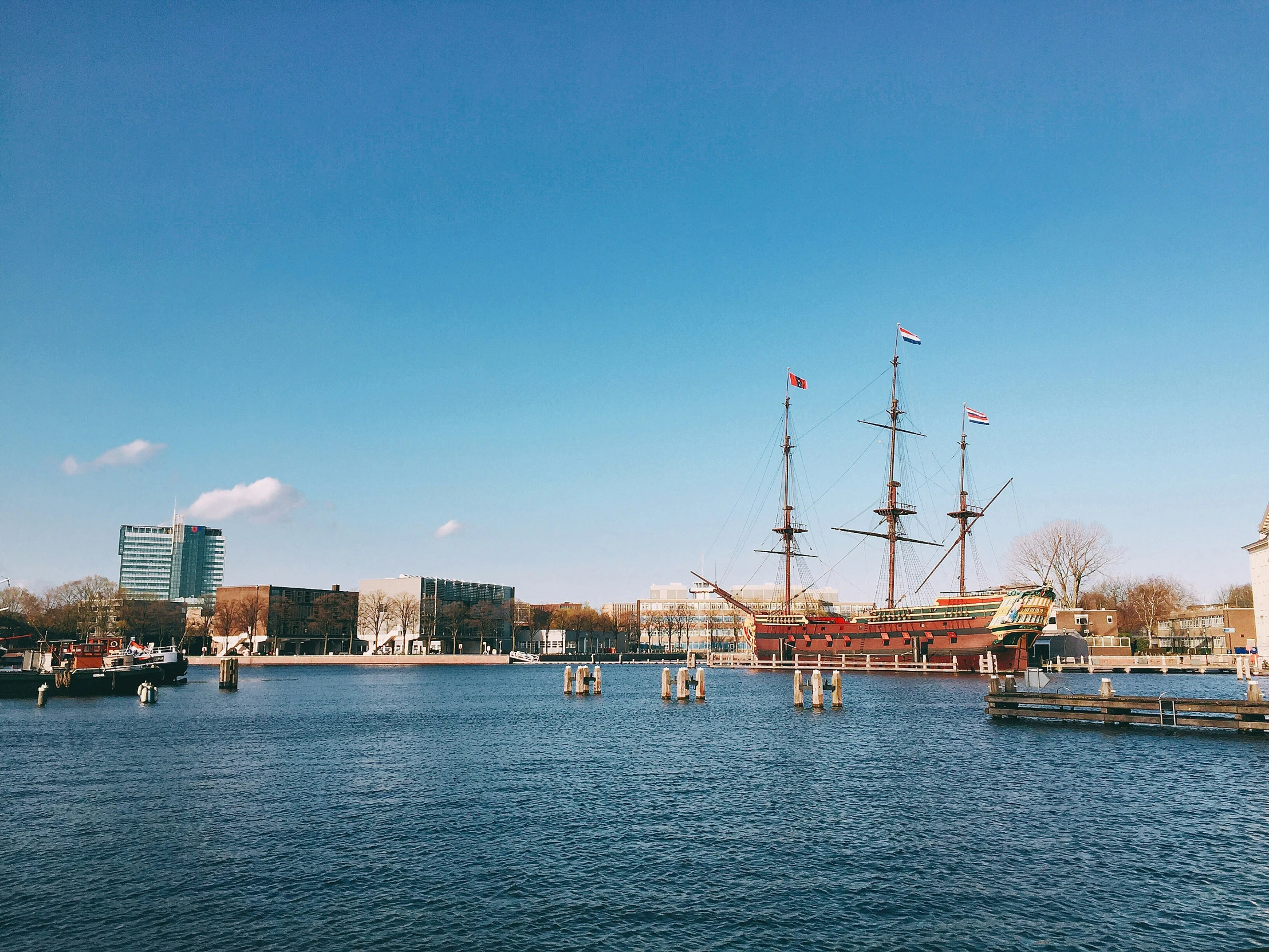 two ships in a body of water near buildings