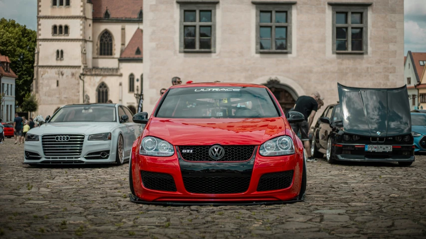 a red car parked on top of a brick road