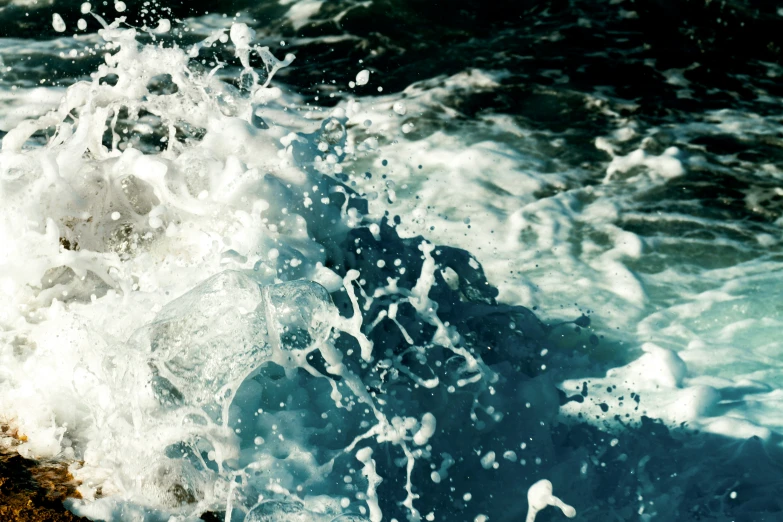 close up of a crashing wave next to the shore