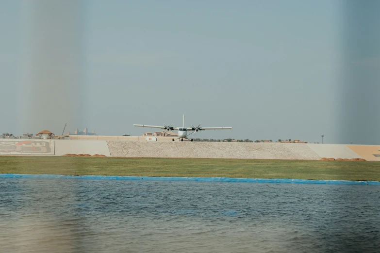 a plane is taking off over the water