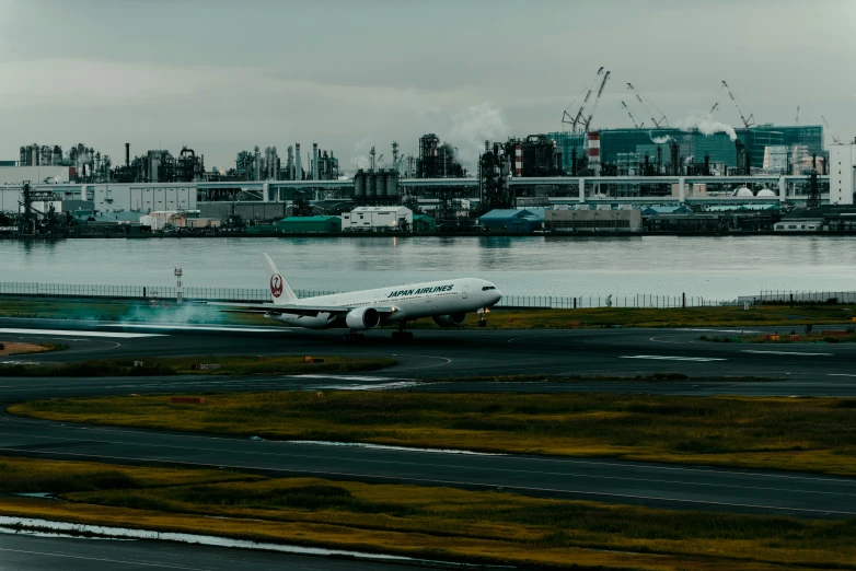 an airplane taking off at an airport next to a harbor