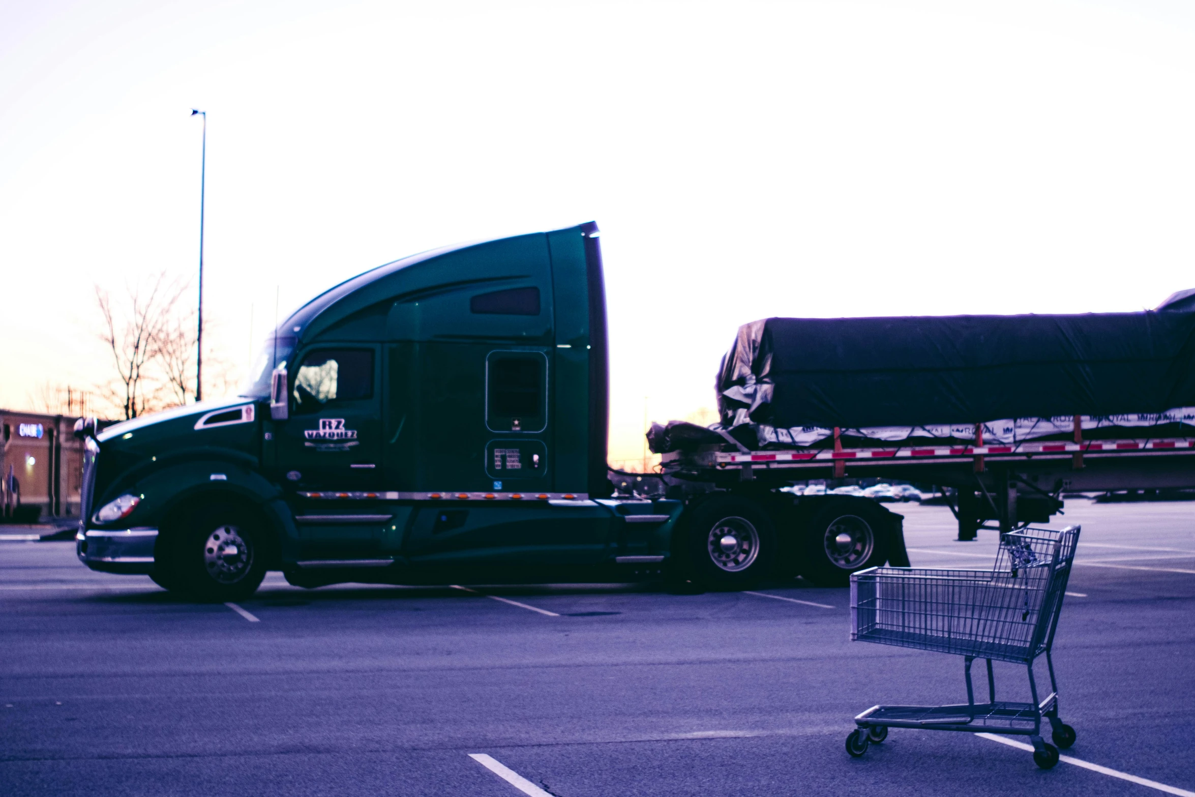 a tractor trailer hauling a large load of furniture