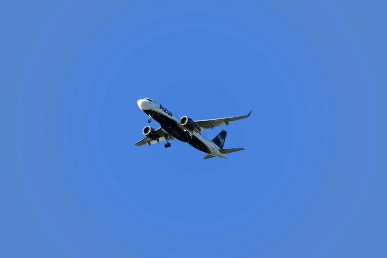 an airplane is flying in the blue sky