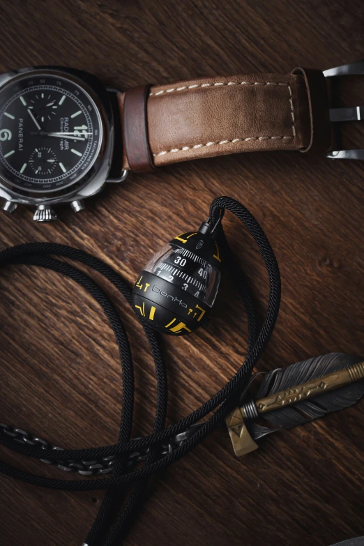 a watch and pen sitting on a table