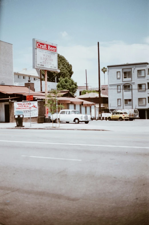 an old car in front of a motel sign