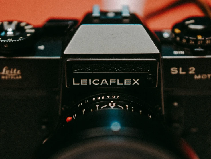 an old camera sits close to two other cameras