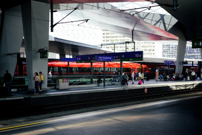 people waiting on the platform at the station