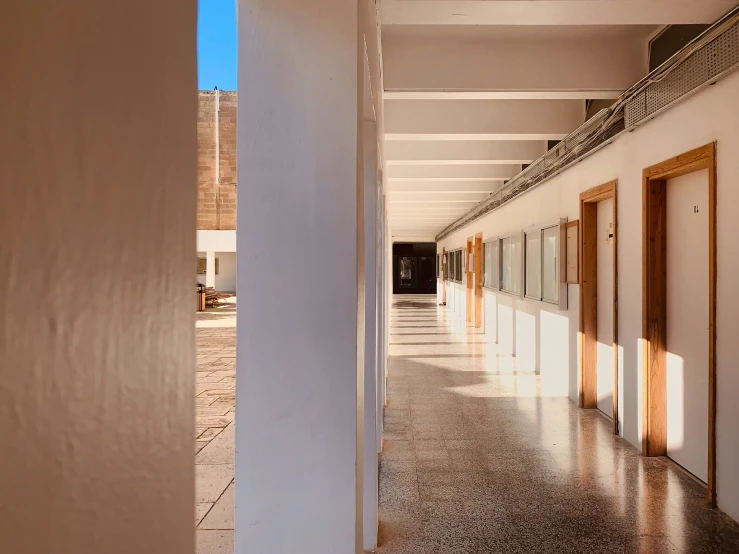 view of hallway from outside with three doors open