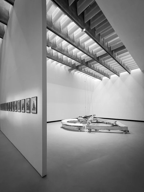 a black and white image of paintings and art in an indoor gallery