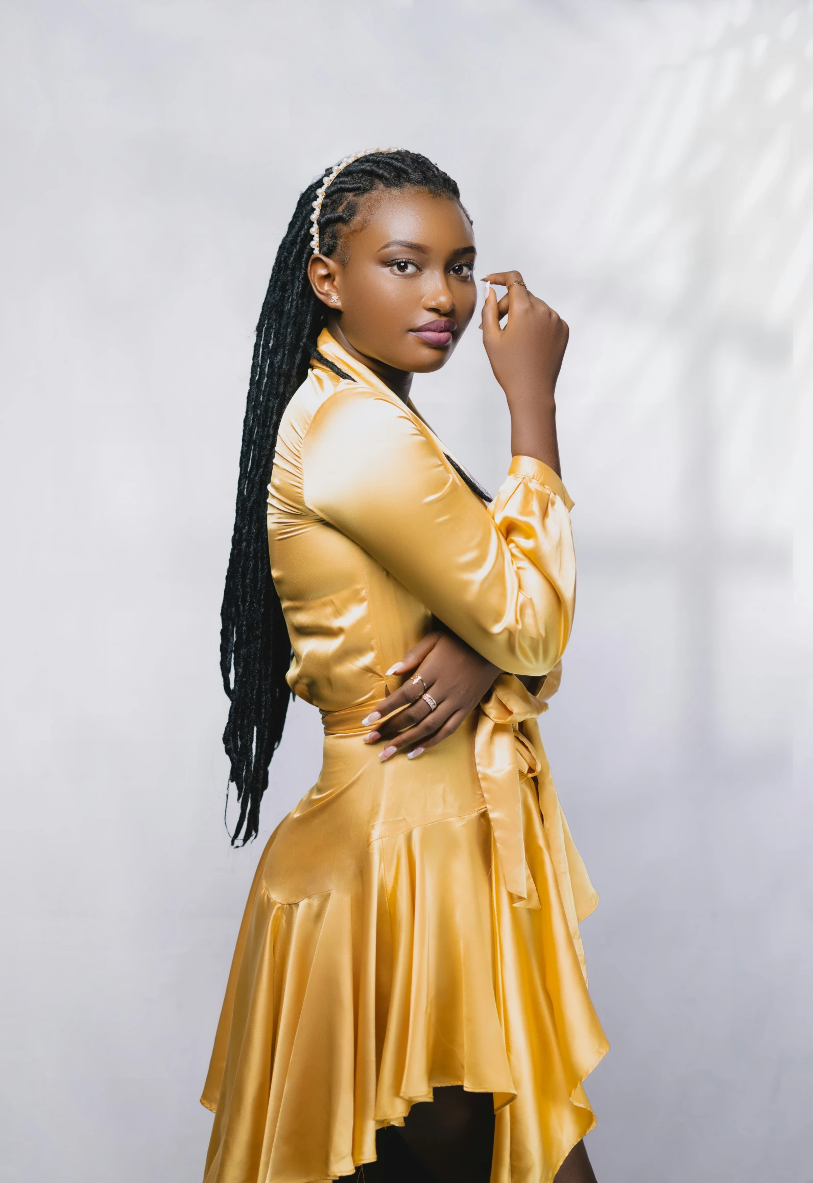 a woman in a gold dress posing for a picture