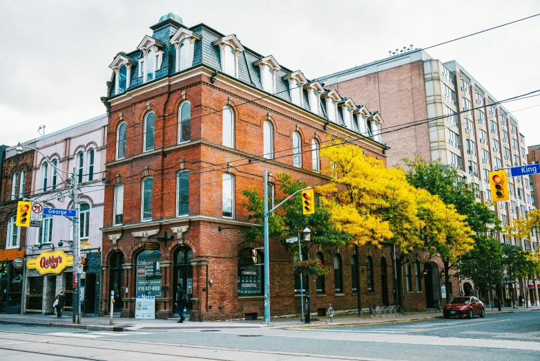 a street with a large brown building and tall buildings