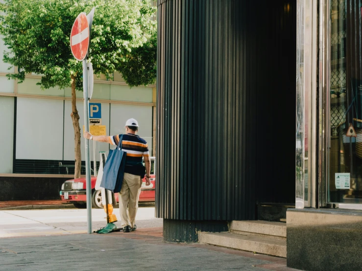 a man who is looking at a parking sign