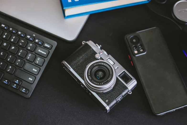 the camera has an old lens in it, next to two new cameras