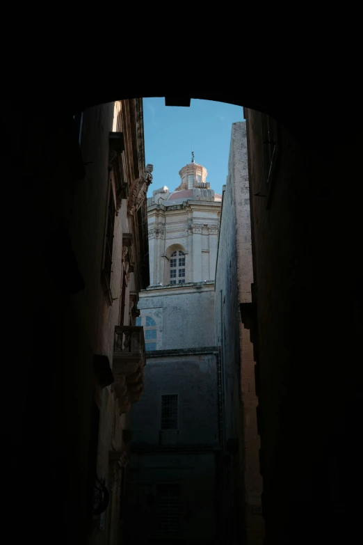 an open doorway shows a cathedral in the distance