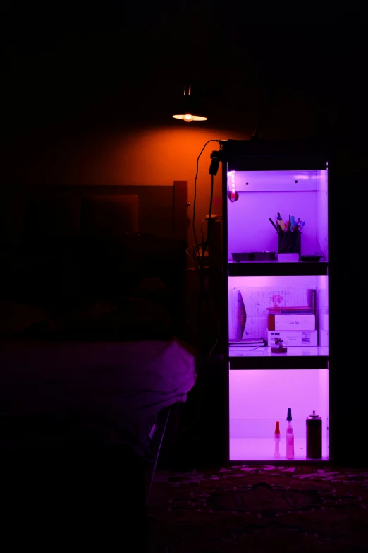 an open refrigerator with the lights on is in the dark