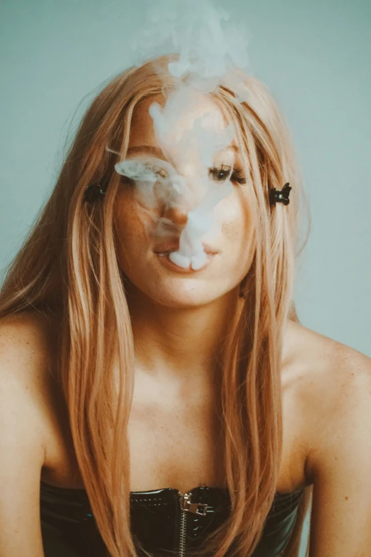 a young woman smoking an electronic cigarette