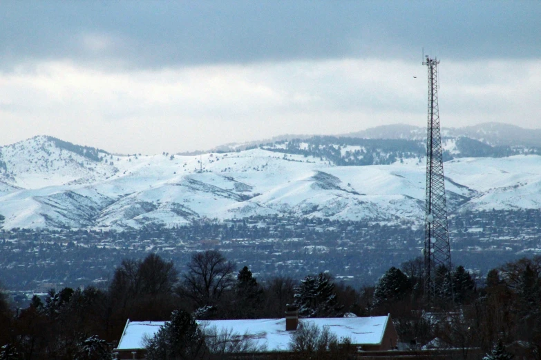 some snow mountains and towers with a few trees