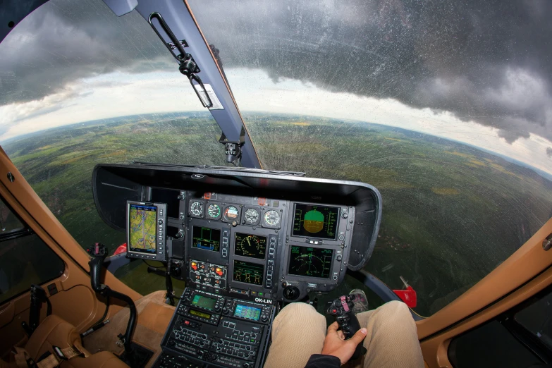 view from inside a plane with a pilot's hand on the control panel