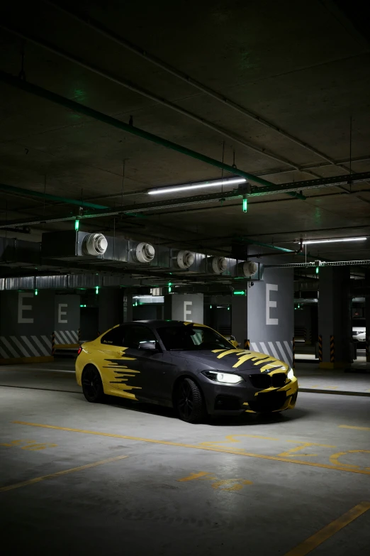 a yellow and black car parked inside a parking garage