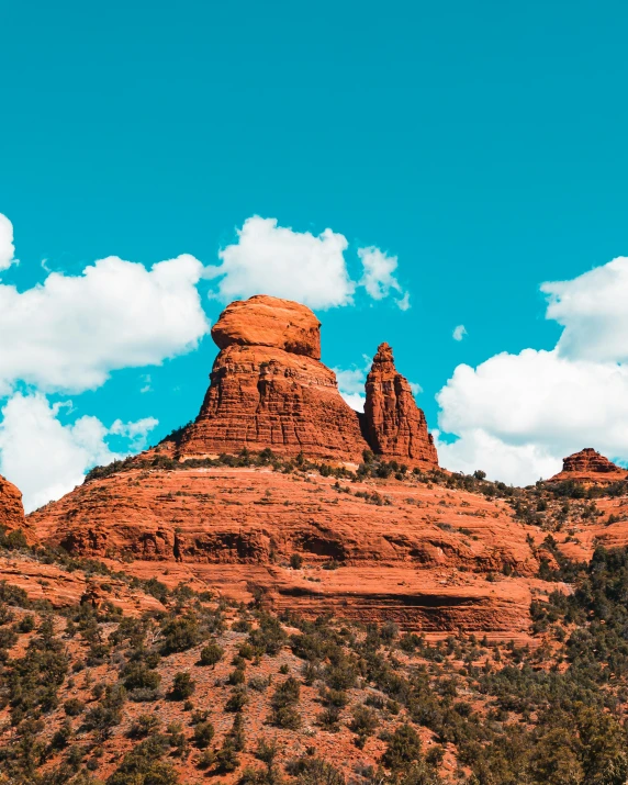 a view of a mountain near some trees and rocks