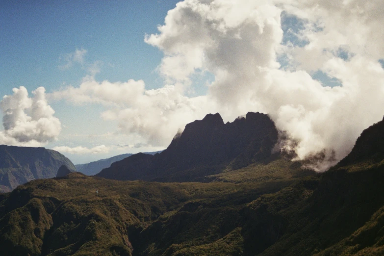 a landscape showing a mountain range with a cloudy sky